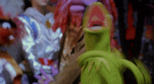 kermit the frog from the sesame street is giving a high five to muppets