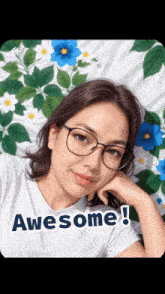 a woman wearing glasses and a white shirt that says awesome on it