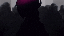 a silhouette of a person standing in the dark
