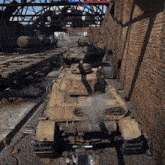 a group of tanks are parked in a warehouse next to a brick wall .