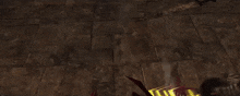 a man in a red jacket is standing next to a statue of a skull in a video game .