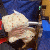 a person is holding a stuffed animal that looks like a donut .