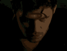 a close up of a man 's face with a black shadow on it .