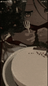 a phone screen shows a girl holding a fork over a plate of food