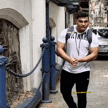 a man wearing a white t-shirt that says ' attack '