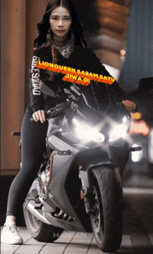 a woman is standing next to a motorcycle that says hansen on the bottom right