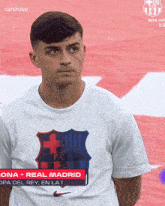 a man wearing a white t-shirt that says real madrid on it