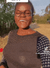 a woman wearing glasses and a black sweater has a tiktok account called officialbabymama