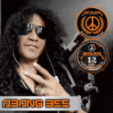 a man wearing sunglasses and a ring with the name abang bee on the bottom left