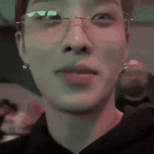a close up of a person wearing glasses and earrings
