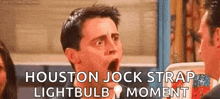 a man with his mouth open is talking to another man while wearing a houston jock strap light bulb moment .