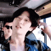 a close up of a man 's face while sitting in a bus .