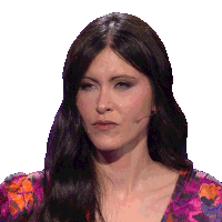 a woman wearing a purple floral shirt has a microphone in her mouth