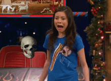a girl in a blue shirt with the word net on it stands in front of a skull