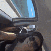 a woman wearing sunglasses and a hat is sitting in a car