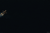 a man in a futuristic armor stands in a dark room