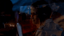 a woman in a white jacket is smiling and looking at a man