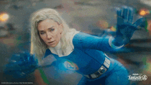 a woman in a blue superhero costume is featured in an advertisement for fantastic four