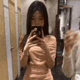 a woman taking a picture of herself in a bathroom with a sign that says wc on it