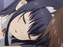 a girl with long dark hair is laying on a bed