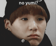 a close up of a person 's face with the words " no yumi " written above it