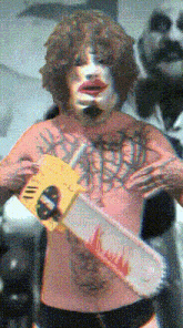 a man in a clown costume holding a chainsaw