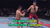 two men are fighting in a boxing ring with the words sit down umrat the machine owns you above them