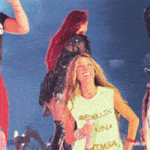 a woman wearing a shirt that says medellin una tumba is smiling