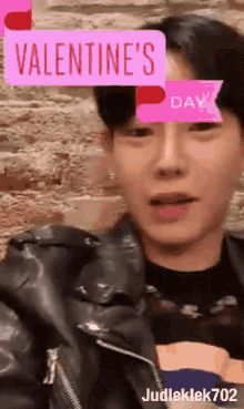a man wearing a leather jacket with a valentine 's day filter on his face .