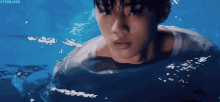 a young man is swimming in a pool with the hashtag #hyunjook