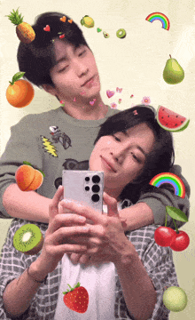 two young men are taking a picture of themselves with fruit stickers on their head
