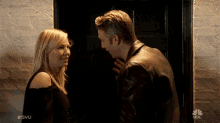 a man and a woman are standing in front of a door that says #svu on it
