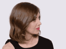 a woman with brown hair is wearing a black dress and red lipstick
