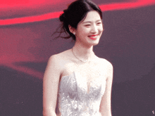 a woman in a white dress is smiling and looking at the camera
