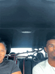 a man and a woman are sitting in a car