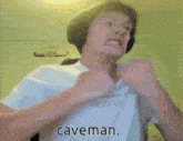 a man without a shirt has the word caveman above his chest