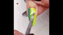 a close up of a person 's nails being painted with a nail polish brush .