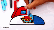 a person is drawing among us characters on a piece of paper with markers .