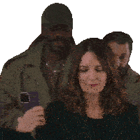 a woman is looking down while a man takes a picture with his phone