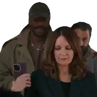 a woman is looking down while a man takes a picture with his phone