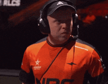 a man wearing headphones and a shirt that says rlcs