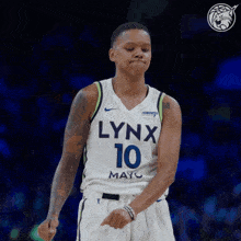 a woman wearing a lynx 10 jersey is dancing