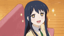 a girl with long blue hair is sitting in a chair and smiling