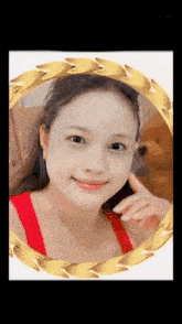 a picture of a woman in a gold frame with a teddy bear behind her