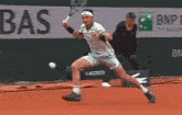 a tennis player is swinging a racket at a tennis ball