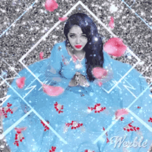 a woman in a blue dress is surrounded by petals and the word weeble