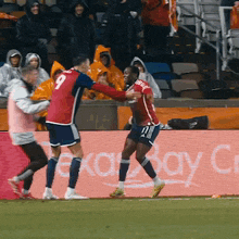 a soccer player with the number 9 on his jersey is being hugged by another player