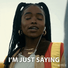 a woman is wearing headphones and says i 'm just saying