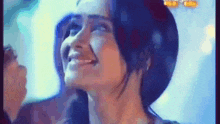 a close up of a woman 's face with a smile on her face .