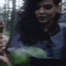 a blurry picture of a woman holding a sword